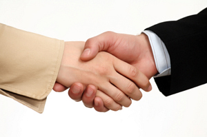 Two people shaking hands in agreement.